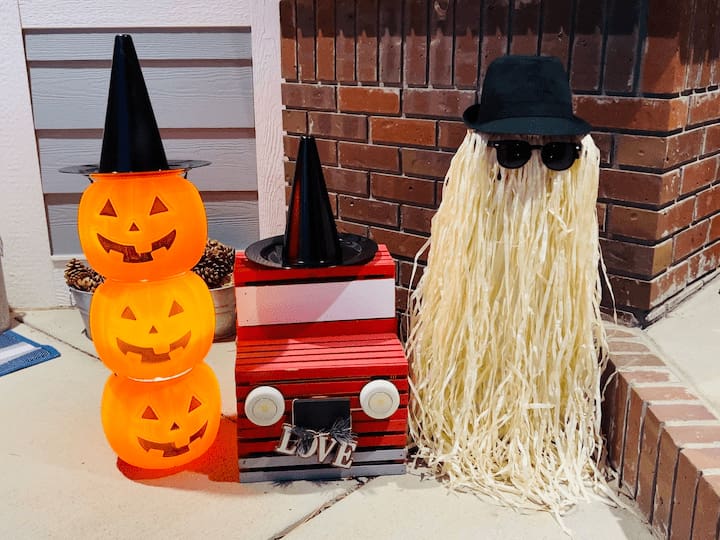 I turned them on and I decided to add one of those witch hats to the top of my topiary. I decided to add this next to my little red truck and added the other witch hat to it and put it all by Cousin It for a fun display. 