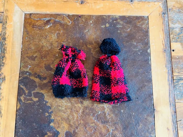 And here are the two hats side by side. One is tassel y and one is the puff ball. Which is your favorite? 