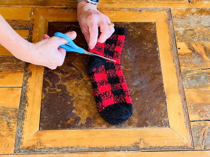 Cutting the fuzzy sock to make the snowman hat