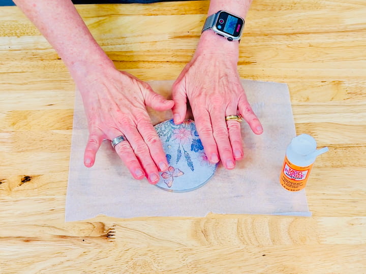 Press the napkin onto the mod podge