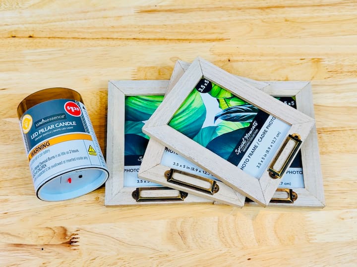 4 picture frames and a battery operated candle