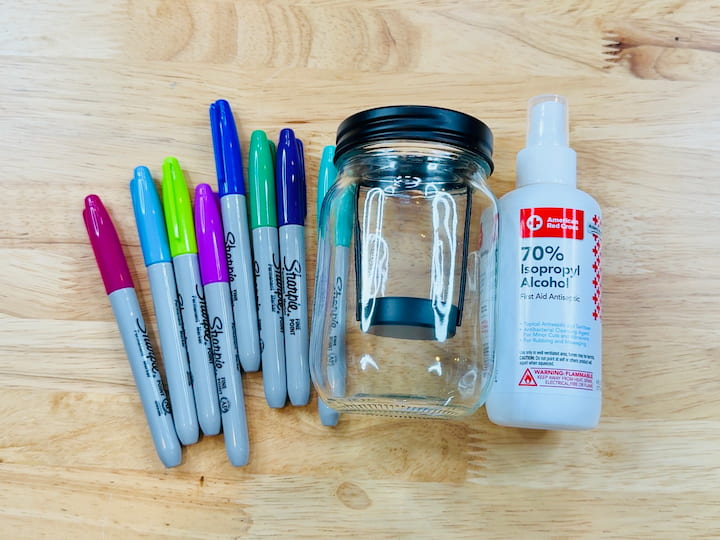 sharpies, candle holder, and rubbing alcohol