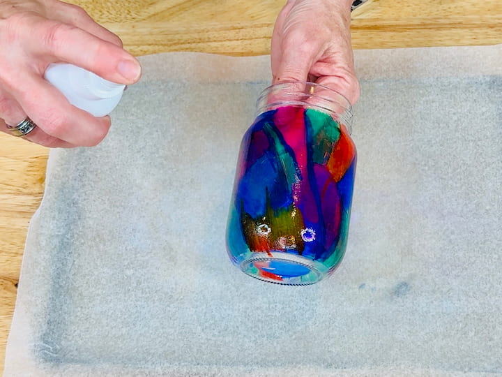 spraying the glass with rubbing alcohol