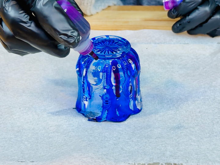 dripping alcohol inks onto the glass candle holder to color the glass
