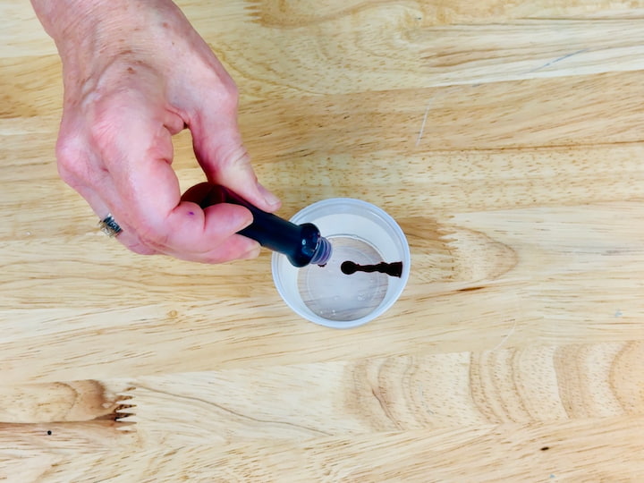 pouring food color into clear glue