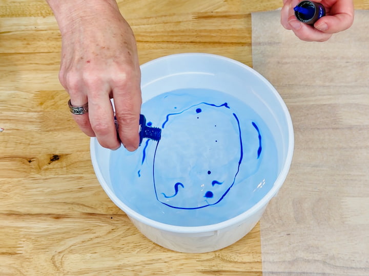 pouring nail polish into hot water