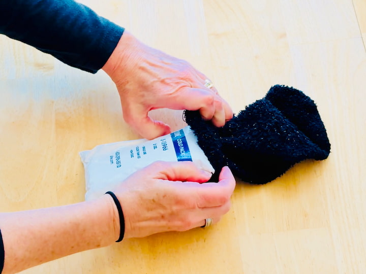 Commercial ice pack being put in an old sock