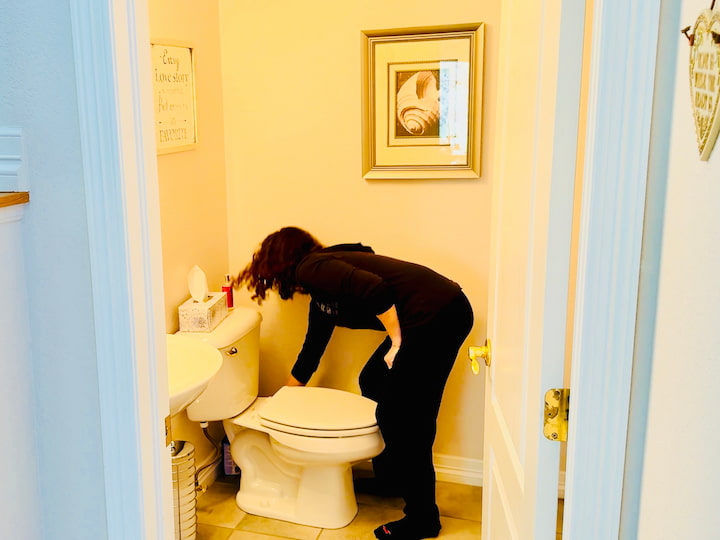 Chas placing sock deodorizer in a bathroom