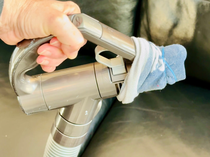 vacuum with a rubberband holding a sock on