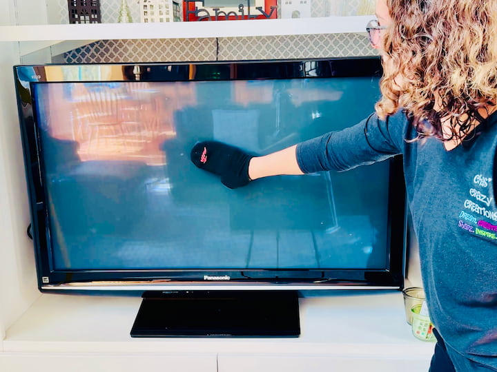 Chas dusting a tv