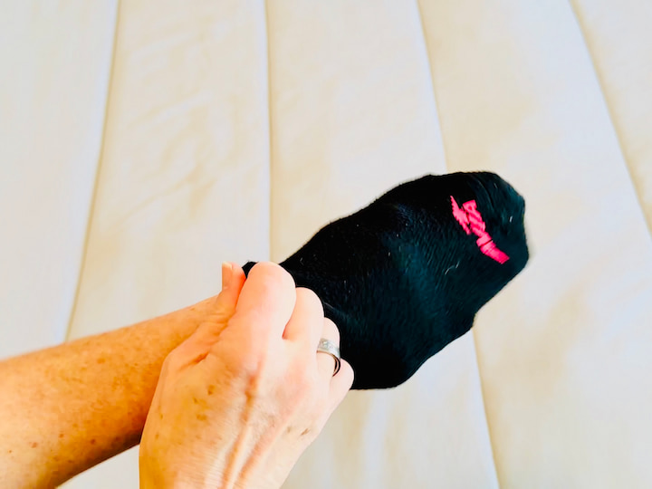 Chas putting sock on her hand