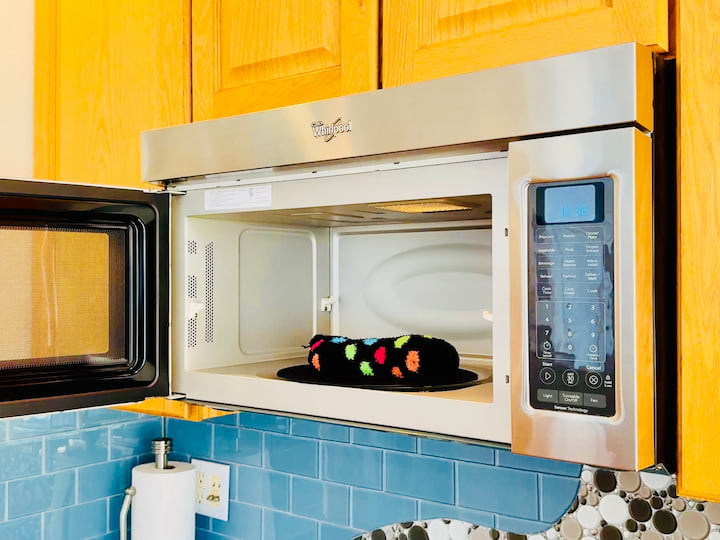 Place the sock in the microwave to warm it up