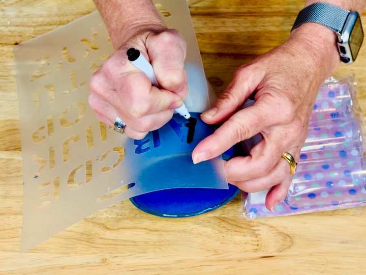 using a dry erase marker and stencil on the mug