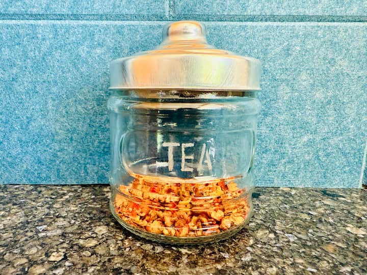 Engraved glass jar with tea inside