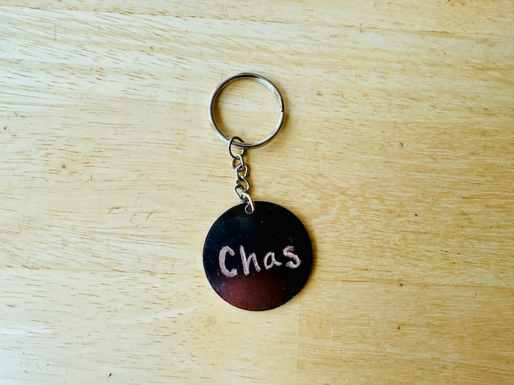 Engraved backside of metal keychain
