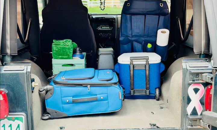 Suitcase: Tucked securely in the back
