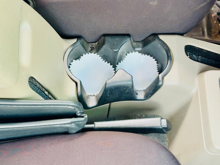 Muffin liners in your cup holders catch spills—just lift and toss (or rinse).