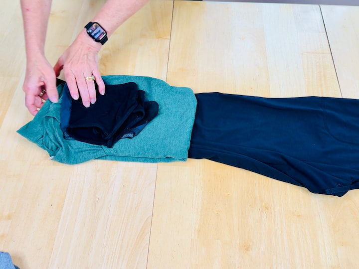 Chas rolling outfits together for travel hack space