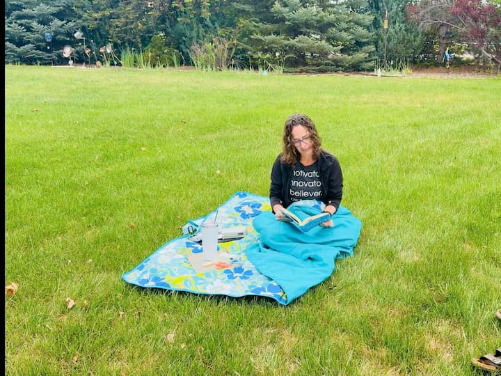 Chas using picnic blanket as a blanket for warmth