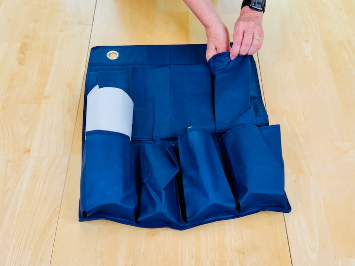 Fill the pockets with:

Sunscreen and bug spray
Card games
Flashlight (mine’s solar powered or wind-up—no batteries needed!)
Disposable rain ponchos
Napkins and antibacterial wipes
Kleenex or paper towels