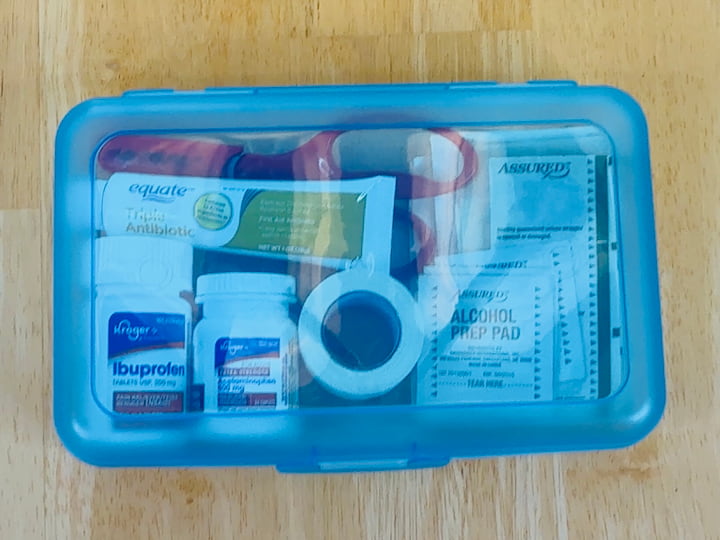 Compact First Aid Kit: I use a plastic school box filled with:
Band-aids
Alcohol wipes
Gauze and scissors
Ibuprofen or Tylenol
Neosporin