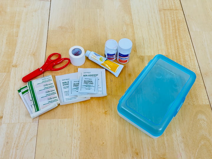 Compact First Aid Kit: I use a plastic school box filled with:
Band-aids
Alcohol wipes
Gauze and scissors
Ibuprofen or Tylenol
Neosporin
