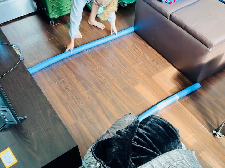 Our journey began with her Kia Soul. Before we packed a single box, we folded down the back seats and measured the cargo space. Then we recreated that space in the apartment living room using pool noodles (you could also use painter’s tape) to stage the items indoors.