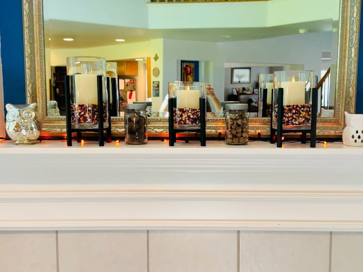 Candle holders with indian corn and LED candles in them on display