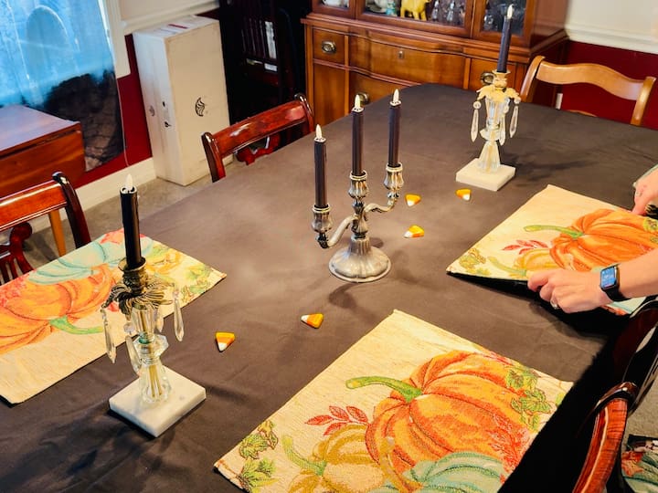 placemats, vintage candle holders, and LED candles on table