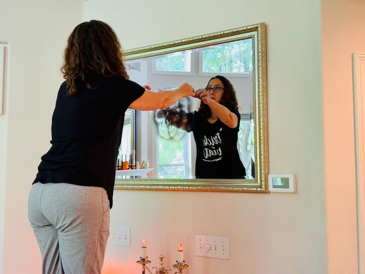 Chas adding window cling to mirror