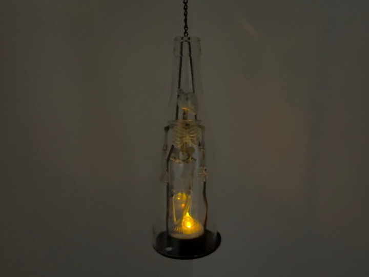 Skeleton in a bottle at night