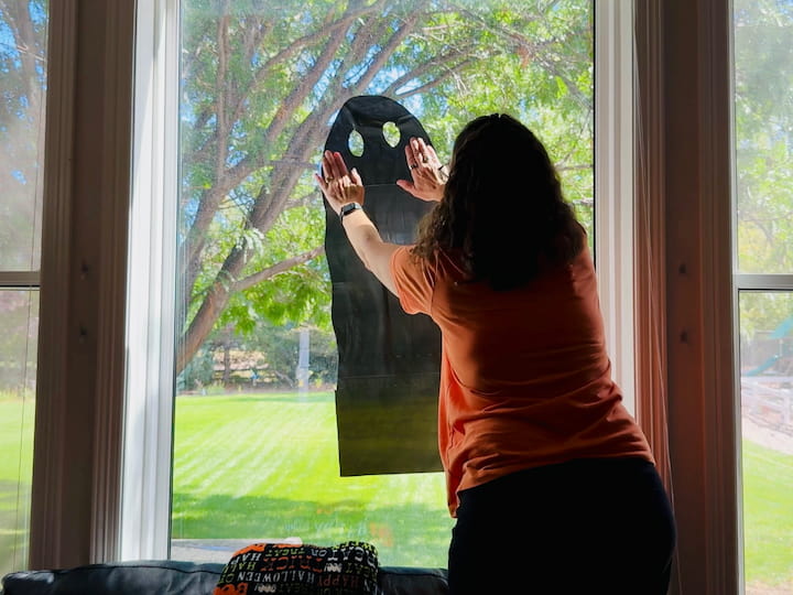 Chas hanging the ghost on the window