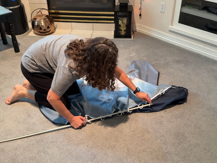 Chas placing shower curtain on tension rod