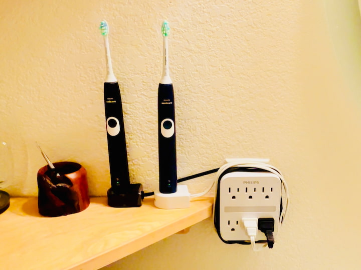 Electronic toothbrushes and cords wrapped around plug