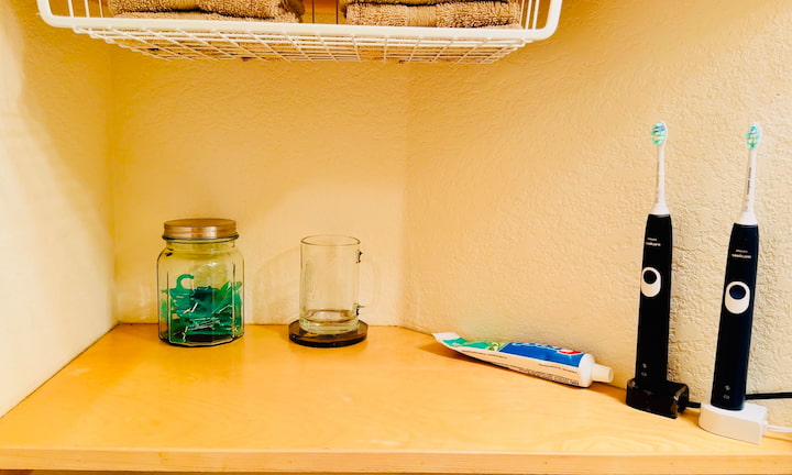 Minimized shelf with toothbrushes, toothpaste, flossers, and cup