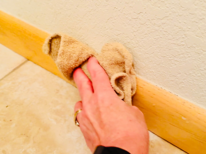 Chas cleaning baseboard