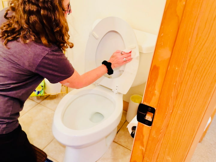 Chas cleaning toilet