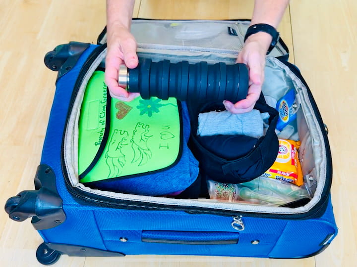 Carry a collapsible water bottle to refill after security.