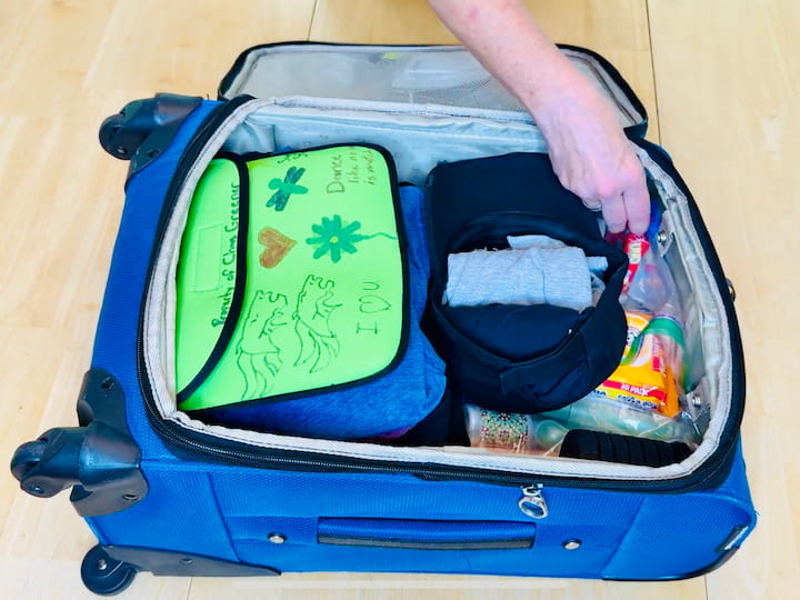 Large scarf rolled for multi-use (blanket, pillow, or wrap).