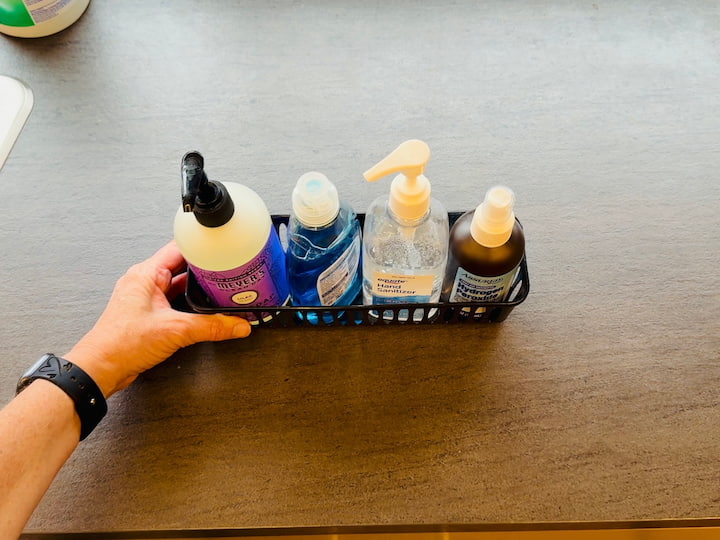 Countertop Caddy: I love these little Dollar Tree containers for my countertops. I put my soap, hand sanitizer, and cleaning supplies in one. The key? I can easily pick up the whole container to wipe underneath it in a pinch!