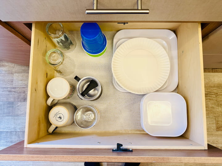 Stacking: We stack dinner plates, salad plates, and bowls, remembering to only keep the quantity we truly need (two of everything, with paper plates for covering splatters).

Glasses: We keep a small, thoughtful number of reusable glasses. If guests come, we can temporarily store extras in an overflow space.